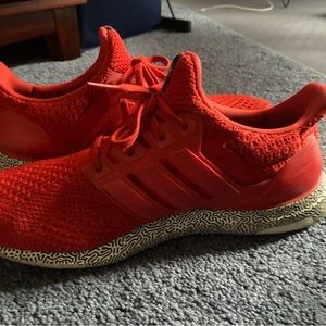 Red ultra boost Adidas running shoes